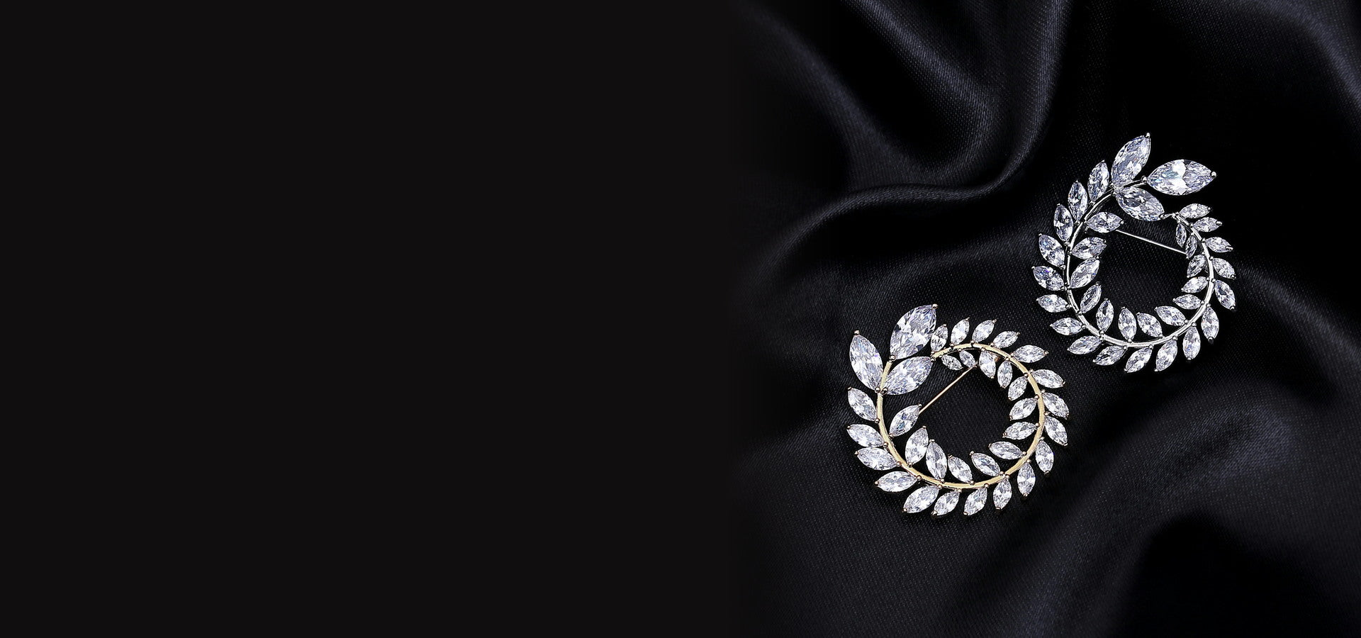 Crystal leaf earrings styled on black satin
